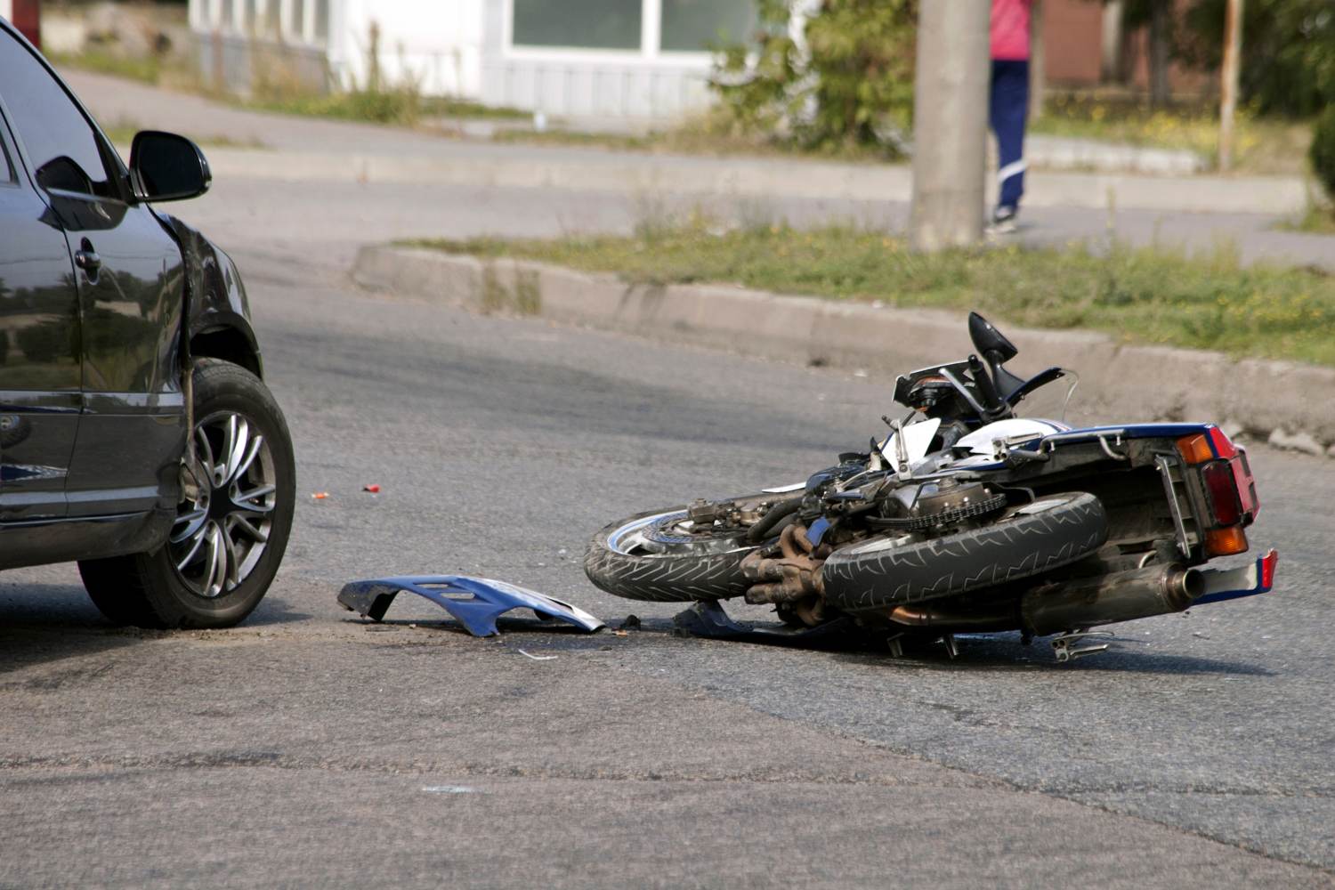 Motorcycle crash with black car